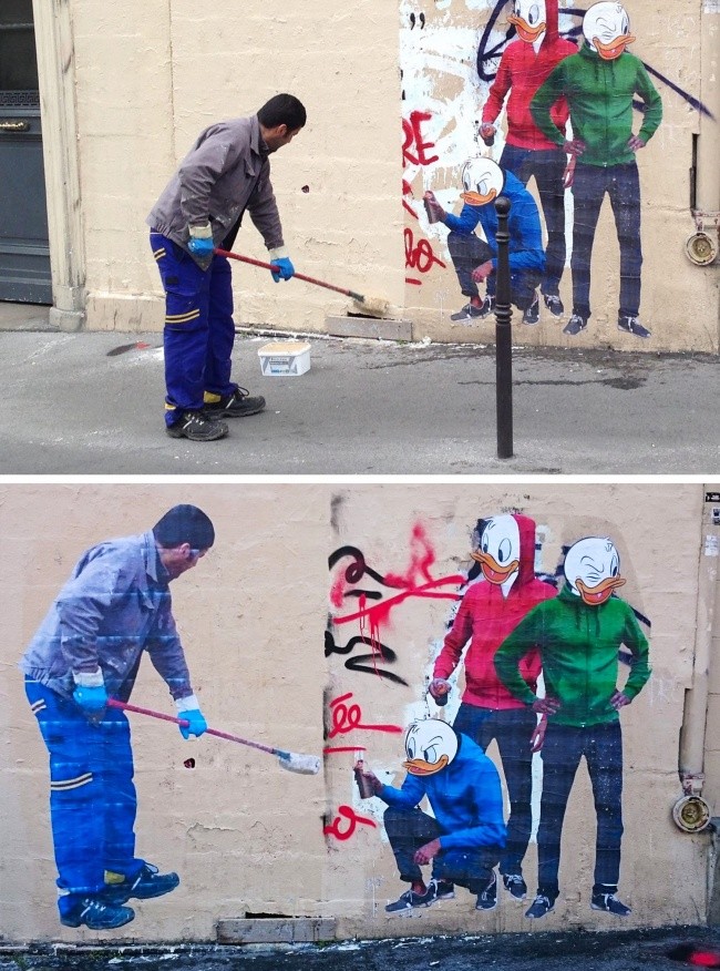 Un employé qui nettoie des graffitis.
