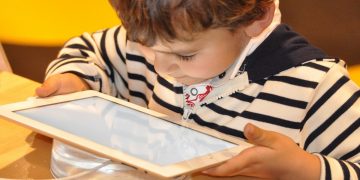 enfant ruine parents en jouant à Soni Force sur la tablette iPad
