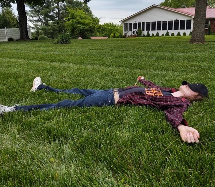 un homme allongé dans l'herbe haute